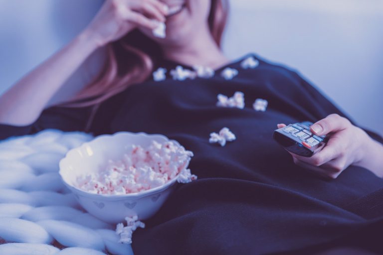 femme regardant une série en mangeant des pop corn